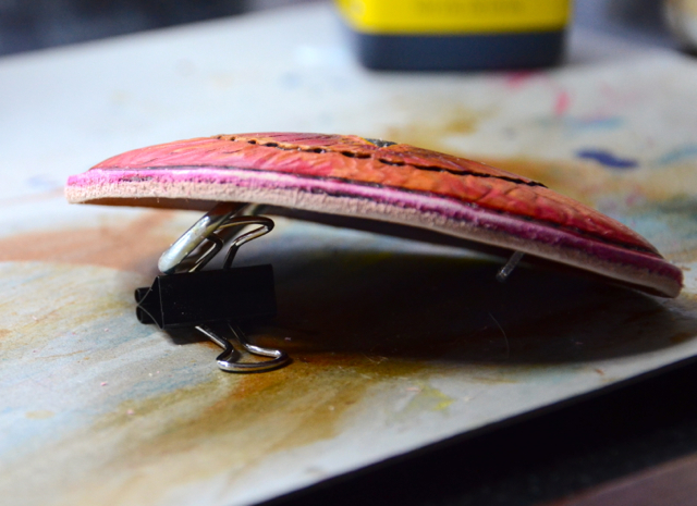 sanding a leather belt buckle