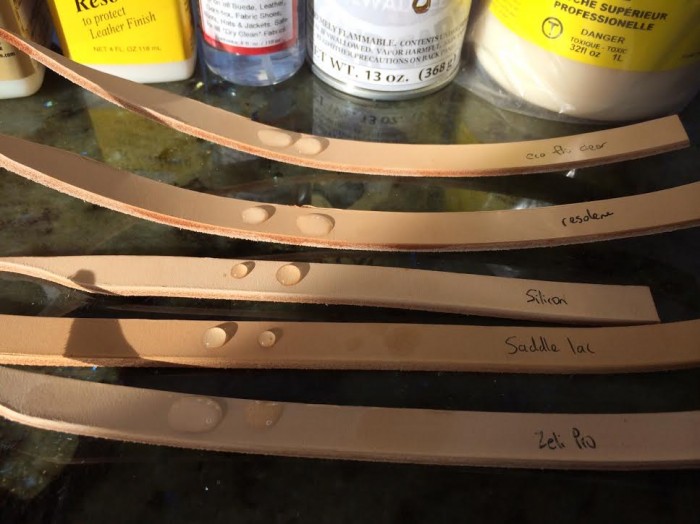 Strips of leather coated with various brands of leather finish. A drop of water is placed on each strip to test waterproofing.